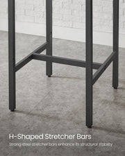 Close-up of the H-shaped steel stretcher bars bracing the four table legs