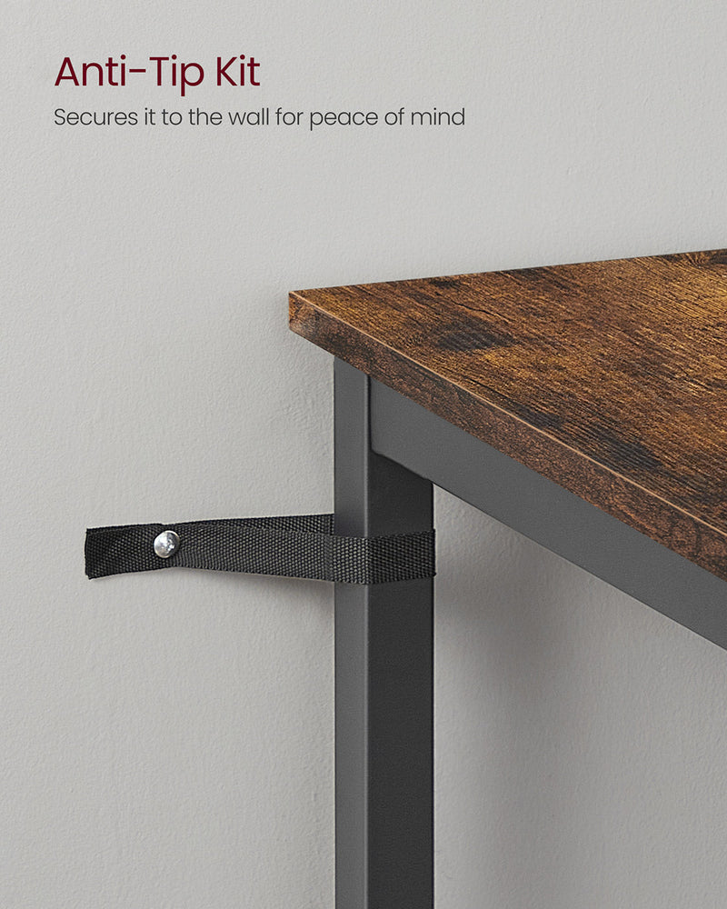 Close-up of the anti-tip wall strap securing a table leg to the wall