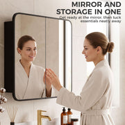 Woman in a bathrobe checking her reflection in the Black mirror cabinet doors