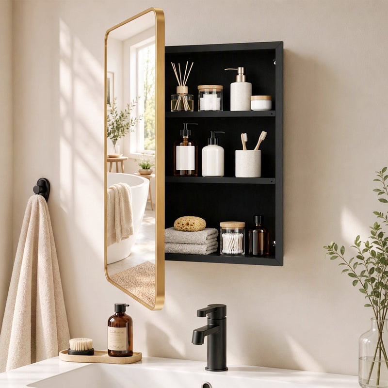 Gold mirror cabinet with the door open showing black shelves with toiletries beside a basin