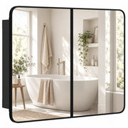Black-framed double door bathroom mirror cabinet reflecting a bathtub and window
