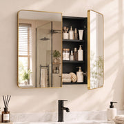 Gold tone mirror cabinet above a basin with one door open and skincare on the shelves