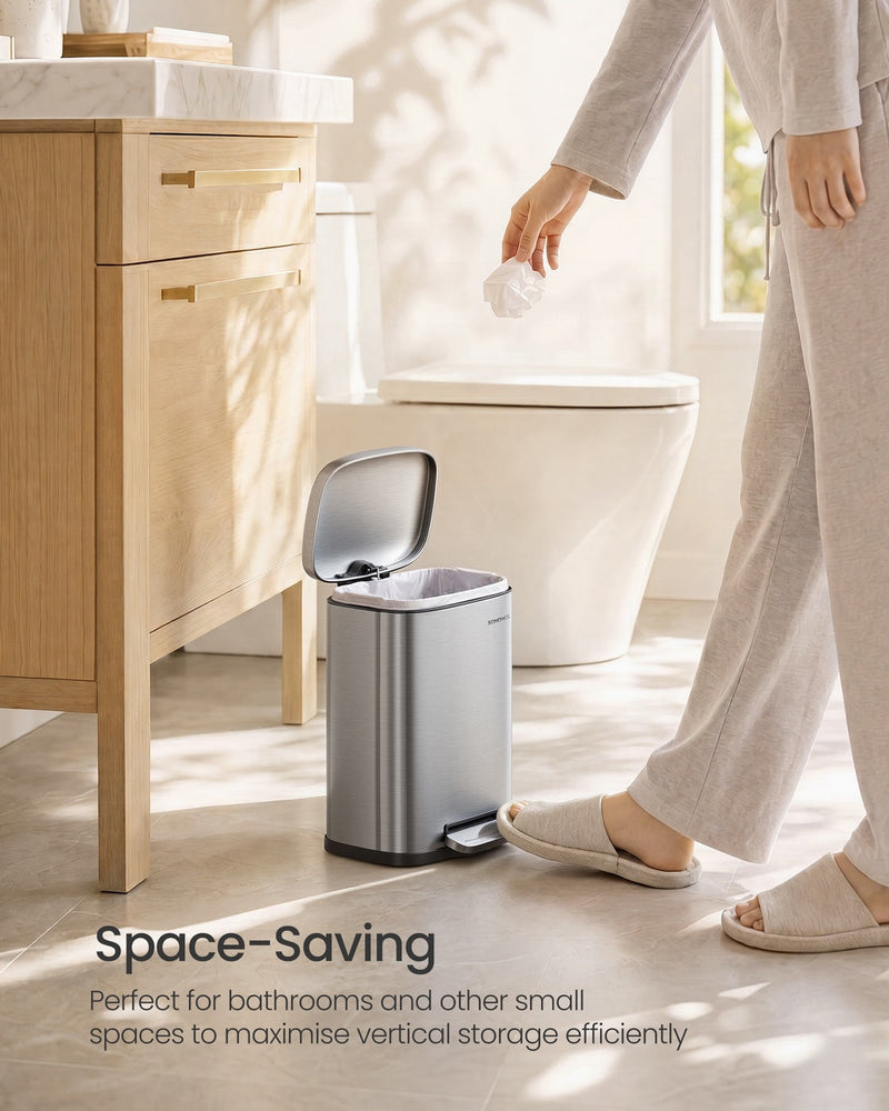 Person stepping on the pedal of the 5 L bin in a bright bathroom, lid open with a liner fitted