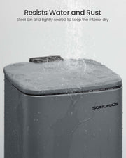 Water running over the closed lid of the grey steel bin to show it resists water and rust