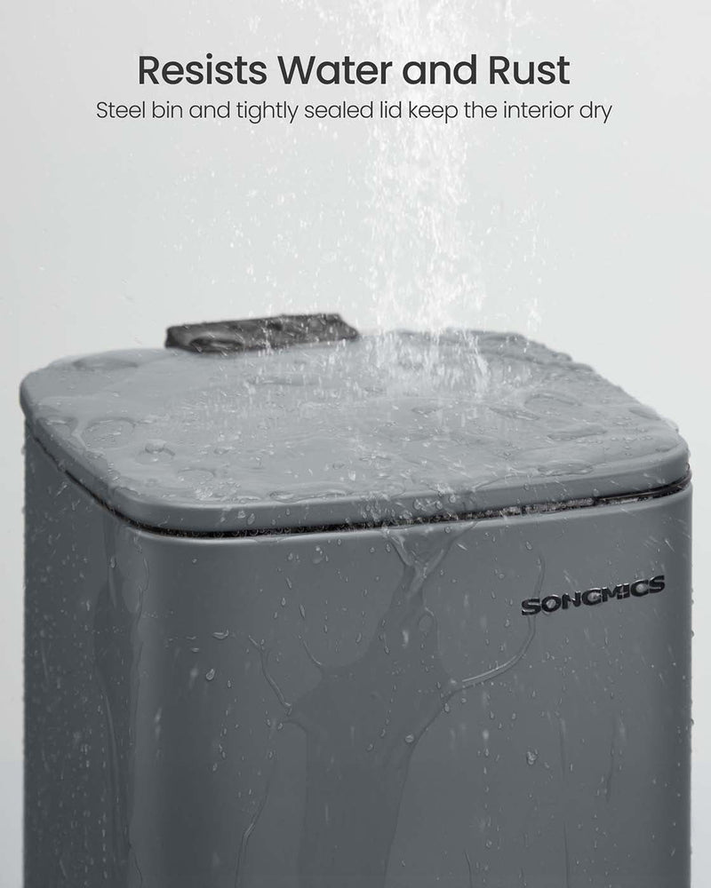 Water running over the closed lid of the grey steel bin to show it resists water and rust