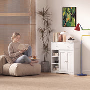 The white cabinet used as living room storage beside a reading chair and floor lamp