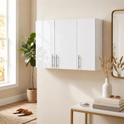 White bathroom wall cabinet mounted in a hallway above a console table