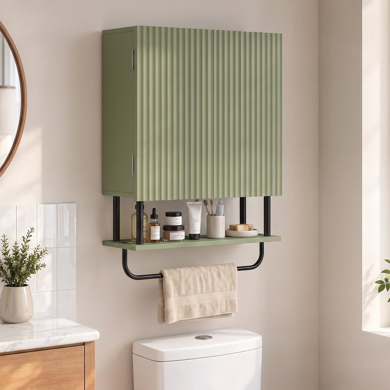 Green wall cabinet mounted above a toilet with toiletries on the open shelf and a beige towel on the rail