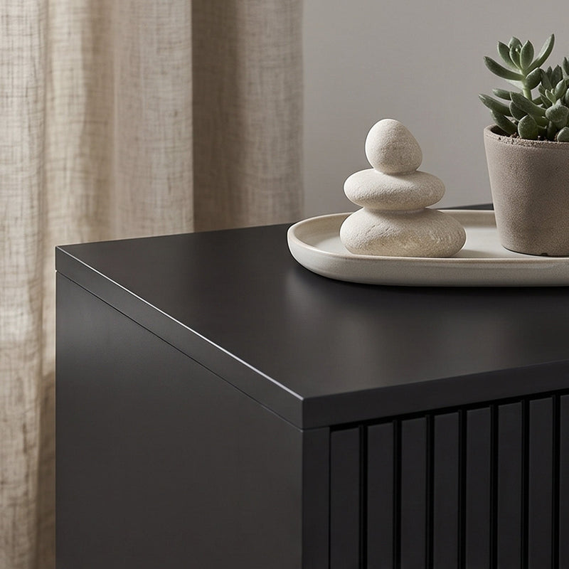 Close-up of black bedside cabinet's tabletop corner and finish