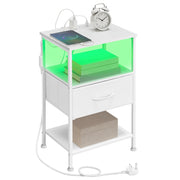 Cloud White bedside table with one fabric drawer and a green-lit open shelf, styled with an alarm clock and a charging phone