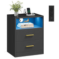 Bedside table with LED-lit open shelf, two gold-handled drawers and a phone charging on top, studio view