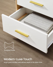 Open drawer with a sculpted gold handle and refined drawer front