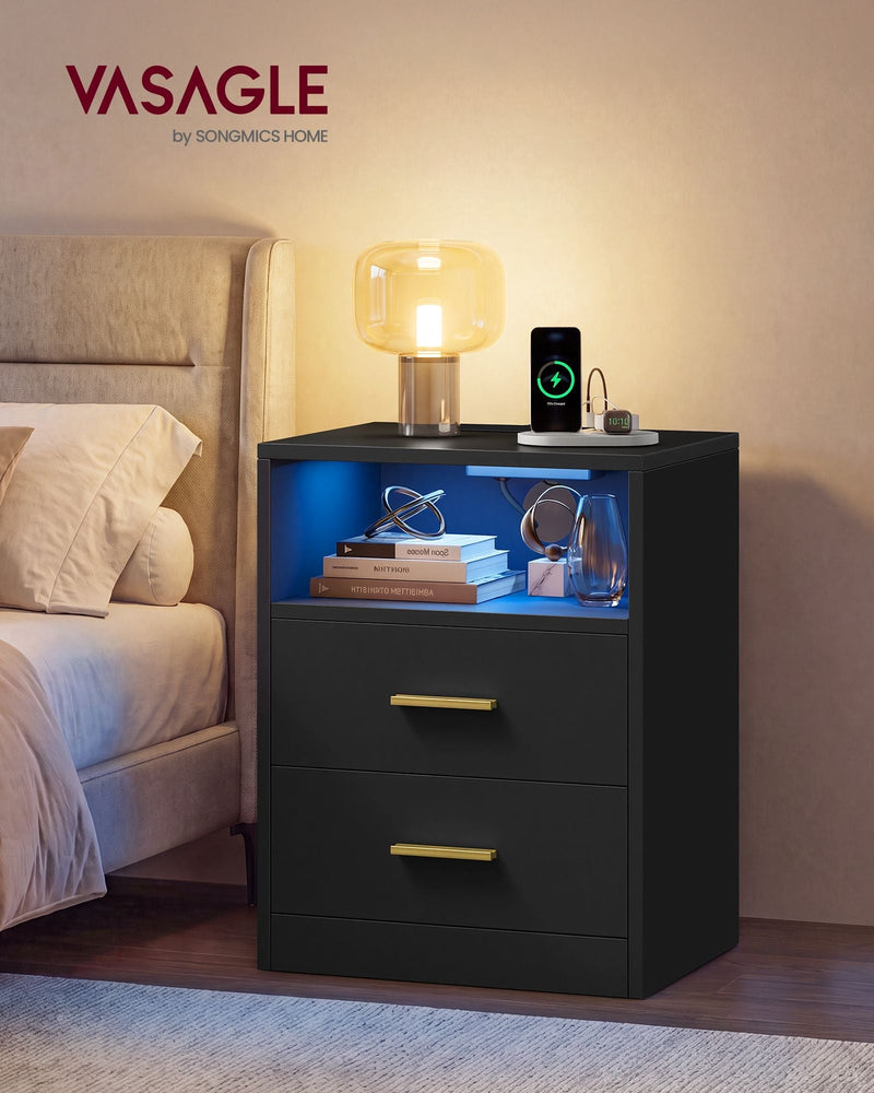 Bedside table beside a bed with a lamp glowing and the LED shelf lit