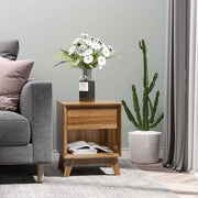 Bedside table in a bedroom with a lamp and plant on top