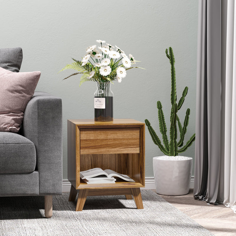 Bedside table in a bedroom with a lamp and plant on top