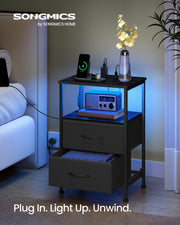 Close-up of the AC and USB charging ports, ink black BELLAH bedside table