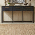 Black 6-drawer console table with gold handles styled in a hallway setting