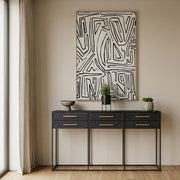 Lifestyle shot of the black console table in a contemporary hallway with the drawers closed