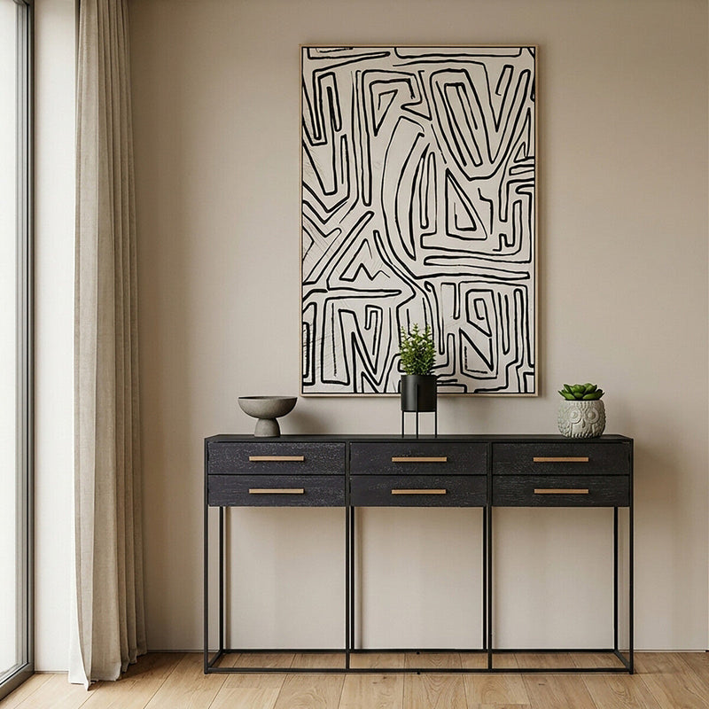 Lifestyle shot of the black console table in a contemporary hallway with the drawers closed
