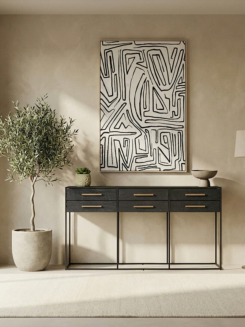 Black console table used as a dining room server in a styled room setting
