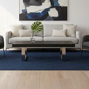 Black ash elm wood coffee table with silver steel legs styled in a living room