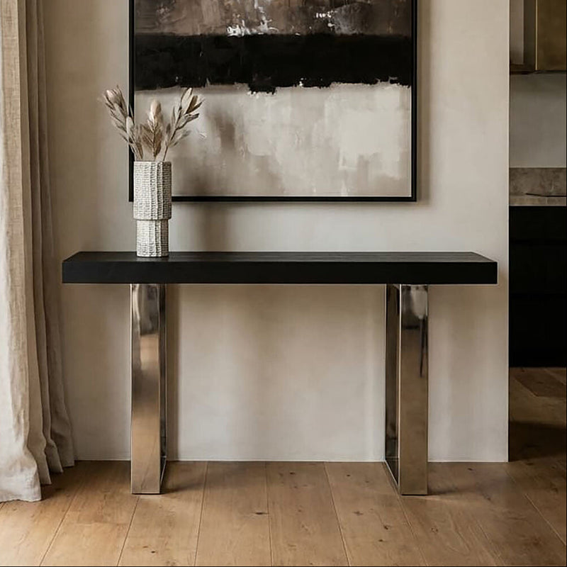 Black ash elm wood console table with silver steel sledge base in a styled room setting
