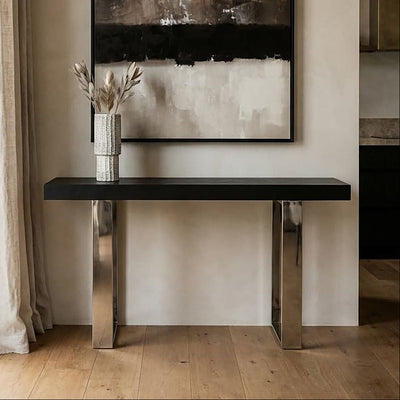 Black ash elm wood console table with silver steel sledge base in a styled room setting