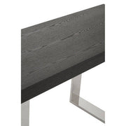 Close-up of the brushed silver stainless steel sledge base of the console table