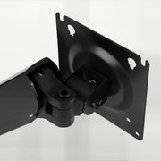Close-up of the black tilting monitor mounting plate on the arm