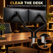 Dual monitor arm clamped to a desk edge with a close-up circle of the C-clamp