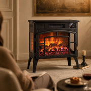 Electric stove fireplace glowing in a living room beside a person on a sofa