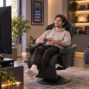 Man playing a game console in the recliner with his feet on the raised footrest