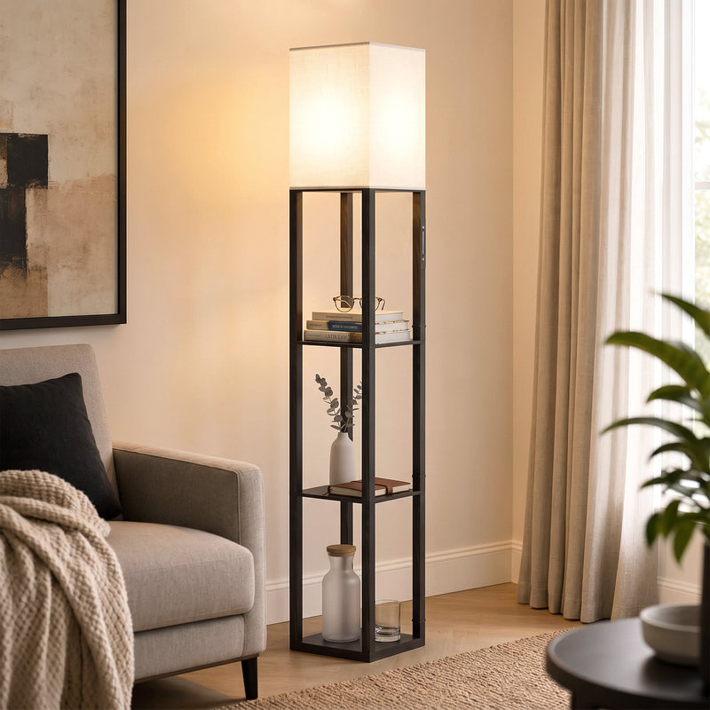 Floor lamp with shelves glowing beside an armchair in a cosy living room