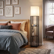 Floor lamp with shelves beside a bed in a calm bedroom