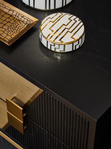 Two drawer side table in a styled bedroom setting with books and decor