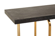 Detail shot of the console table corner where the gold angular frame meets the oak veneer top