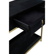 Close-up of the gold-finished foot of the console table frame