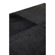 Macro close-up of the black hair-on-hide leather texture on the tabletop