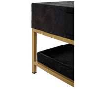 Close-up of the gold metal frame corner joint against the black hide top