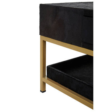 Close-up of the gold metal frame corner joint against the black hide top