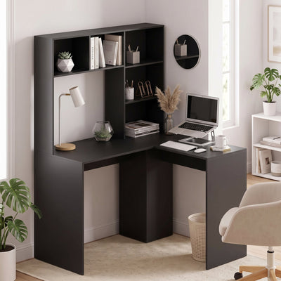 Black L-shaped corner desk in a home office corner with laptop and plants