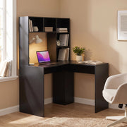 Black corner desk with laptop and lamp in a warm corner