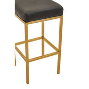 Close-up of gold finish square base on bar stool