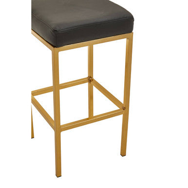Close-up of gold finish square base on bar stool