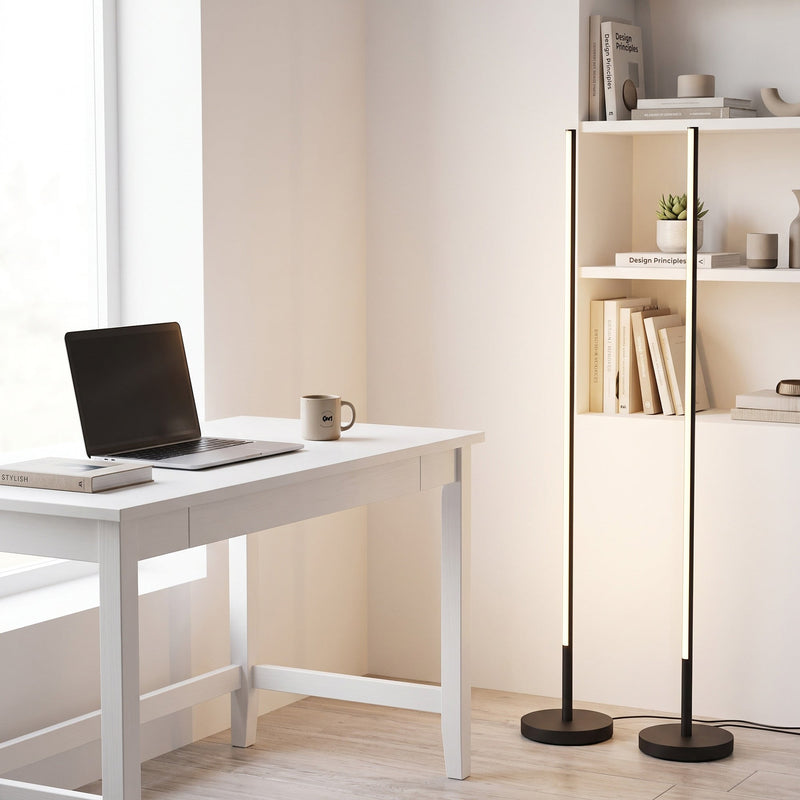 Two black floor lamps beside a white desk and bookshelf