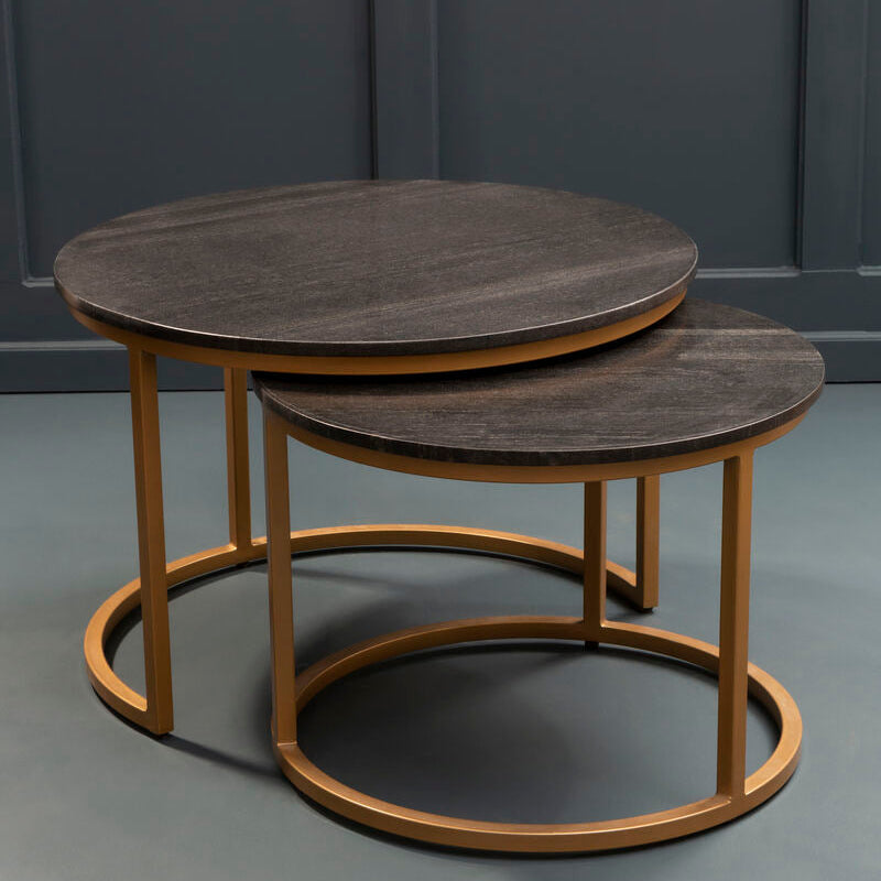 Black marble and gold nesting coffee tables styled in a modern living room beside a sofa