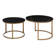 Set of two round black marble coffee tables with gold iron frames, separated, on a plain background