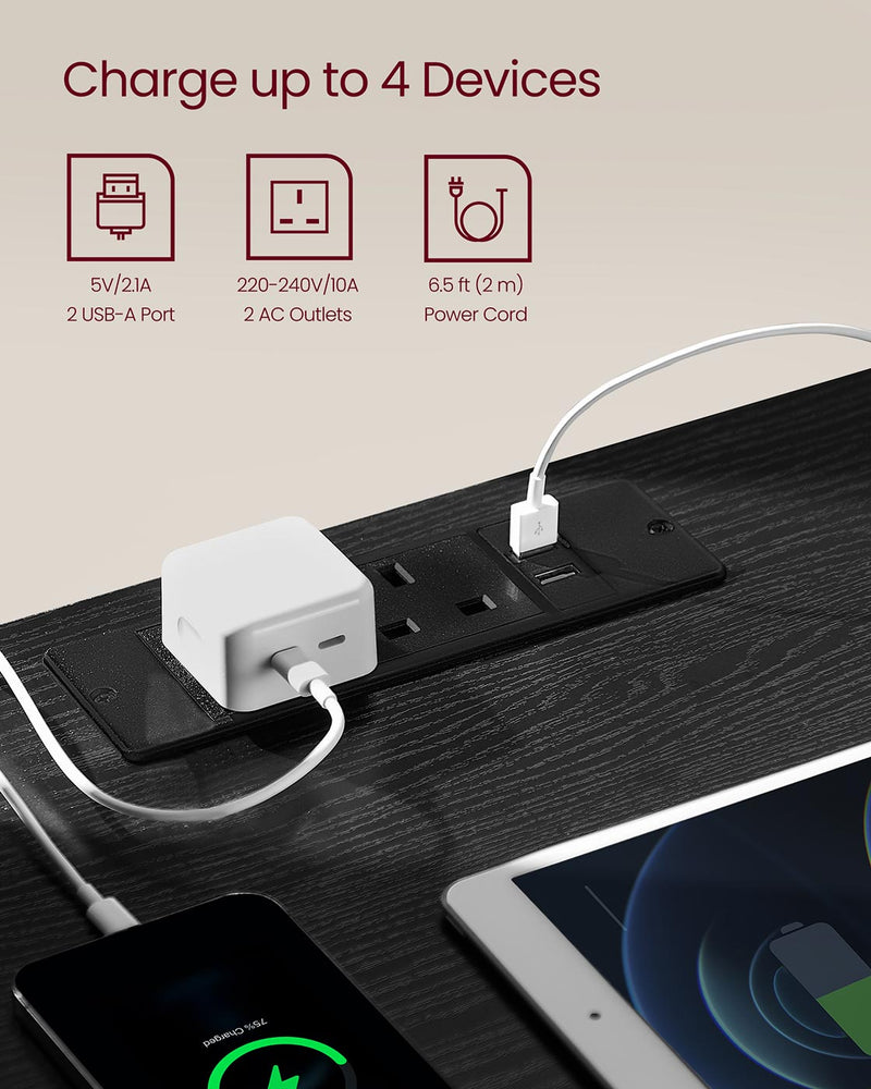 Close-up of the top-mounted power strip with 2 UK sockets and 2 USB-A ports charging a phone and tablet