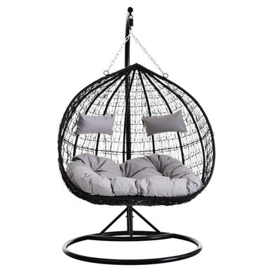 Black rattan double hanging chair with grey cushions, studio shot