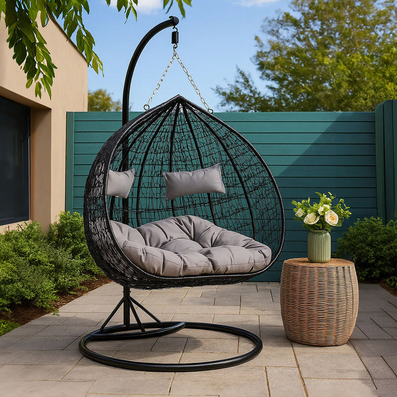 Black rattan double hanging chair styled in a living room setting
